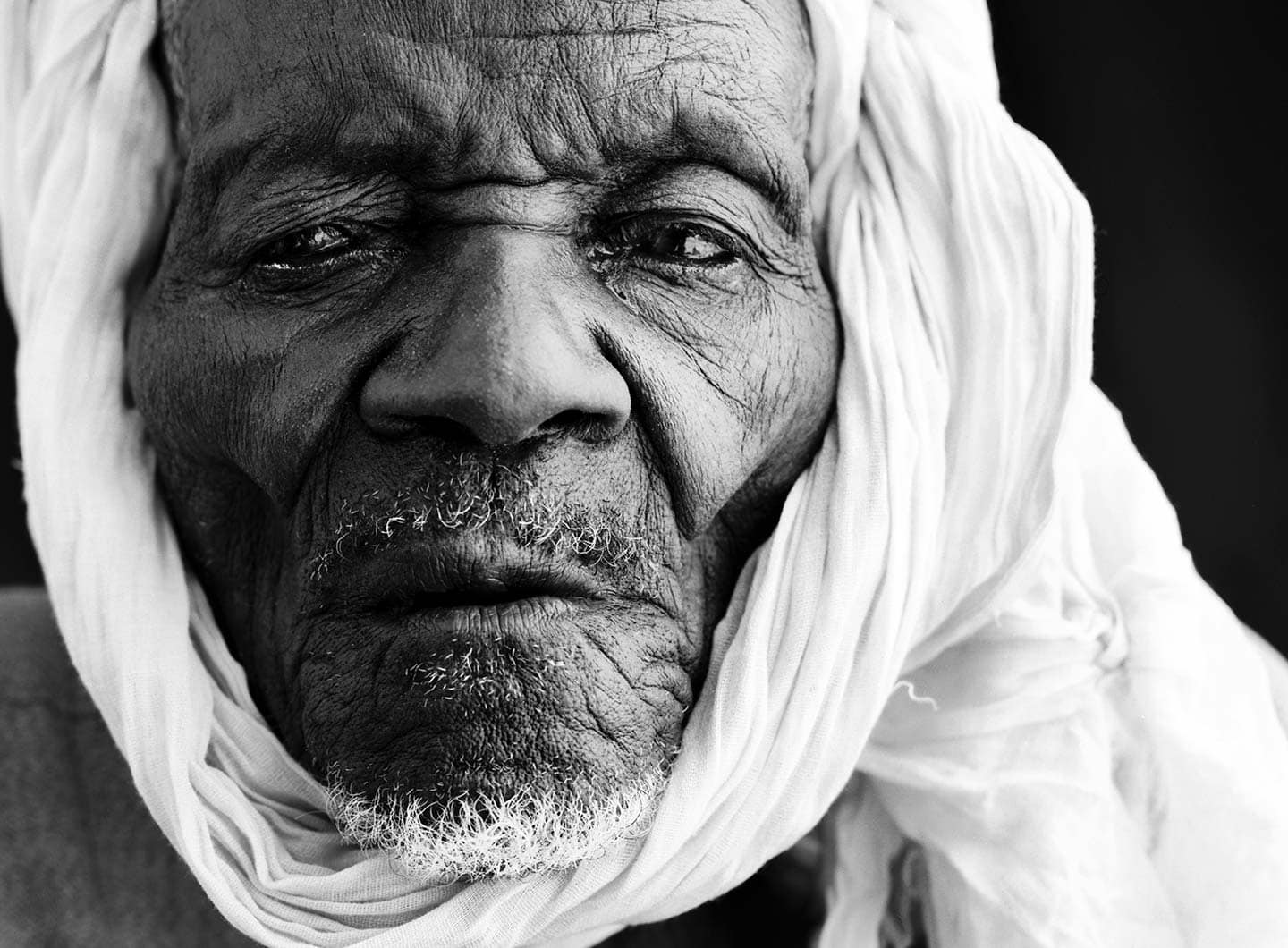 Rod Mclean - portrait of a old african man in white scarf