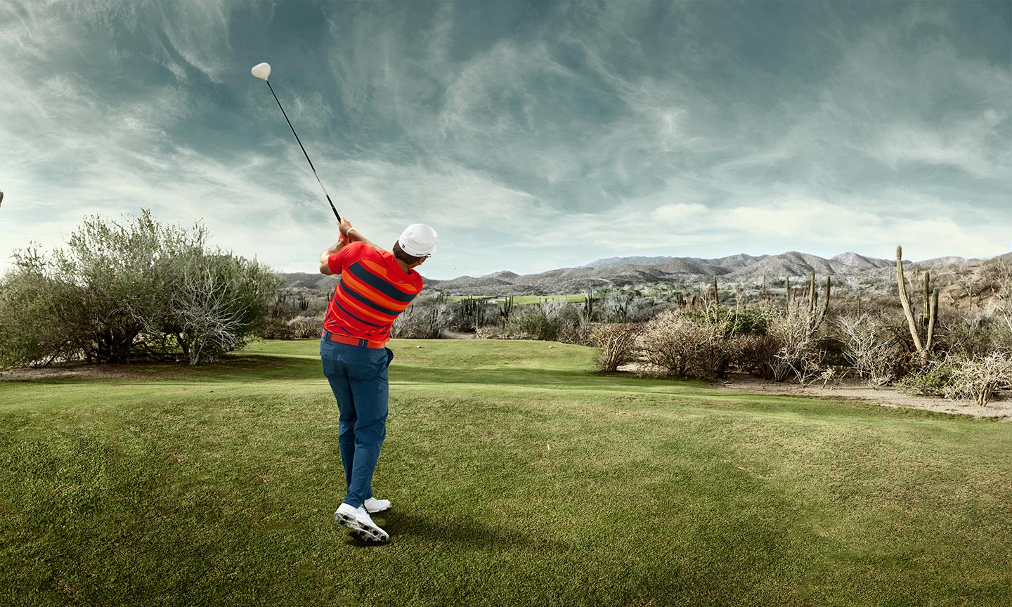 Golfer After Swing Medium Field Shot Behind Background Grey Skies