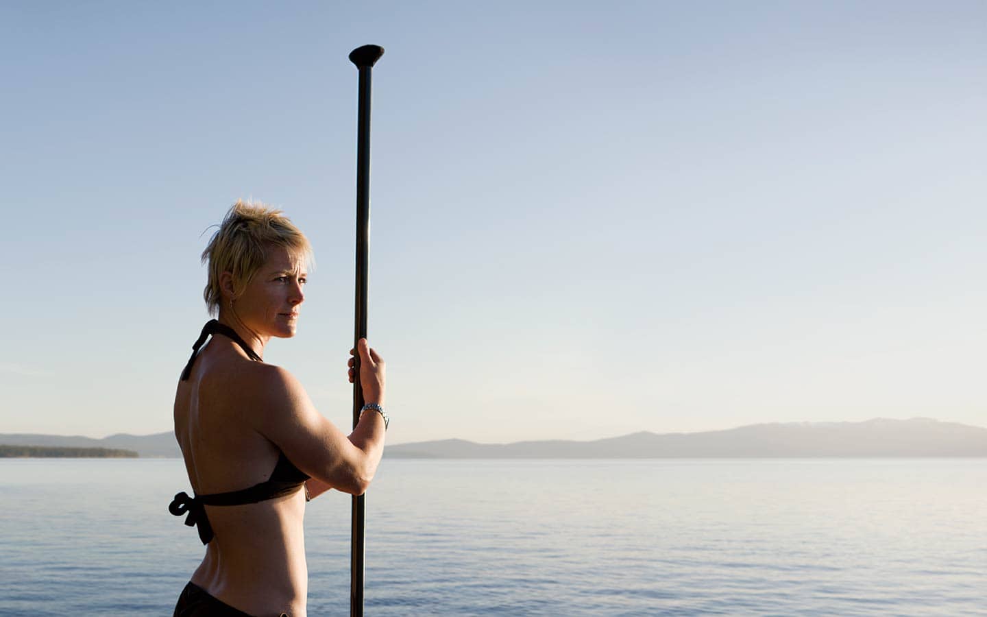 Image of Woman Holding Surf Kayaking Paddle Looking Off to Side