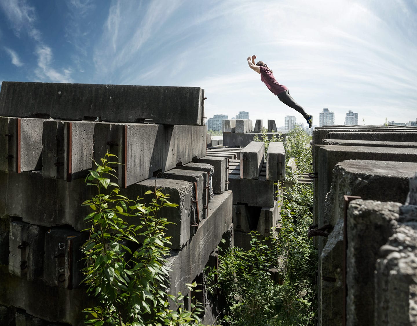 Parkour Athlete Arms Crossed Angled Jump Concrete Walls Background Bright Skies