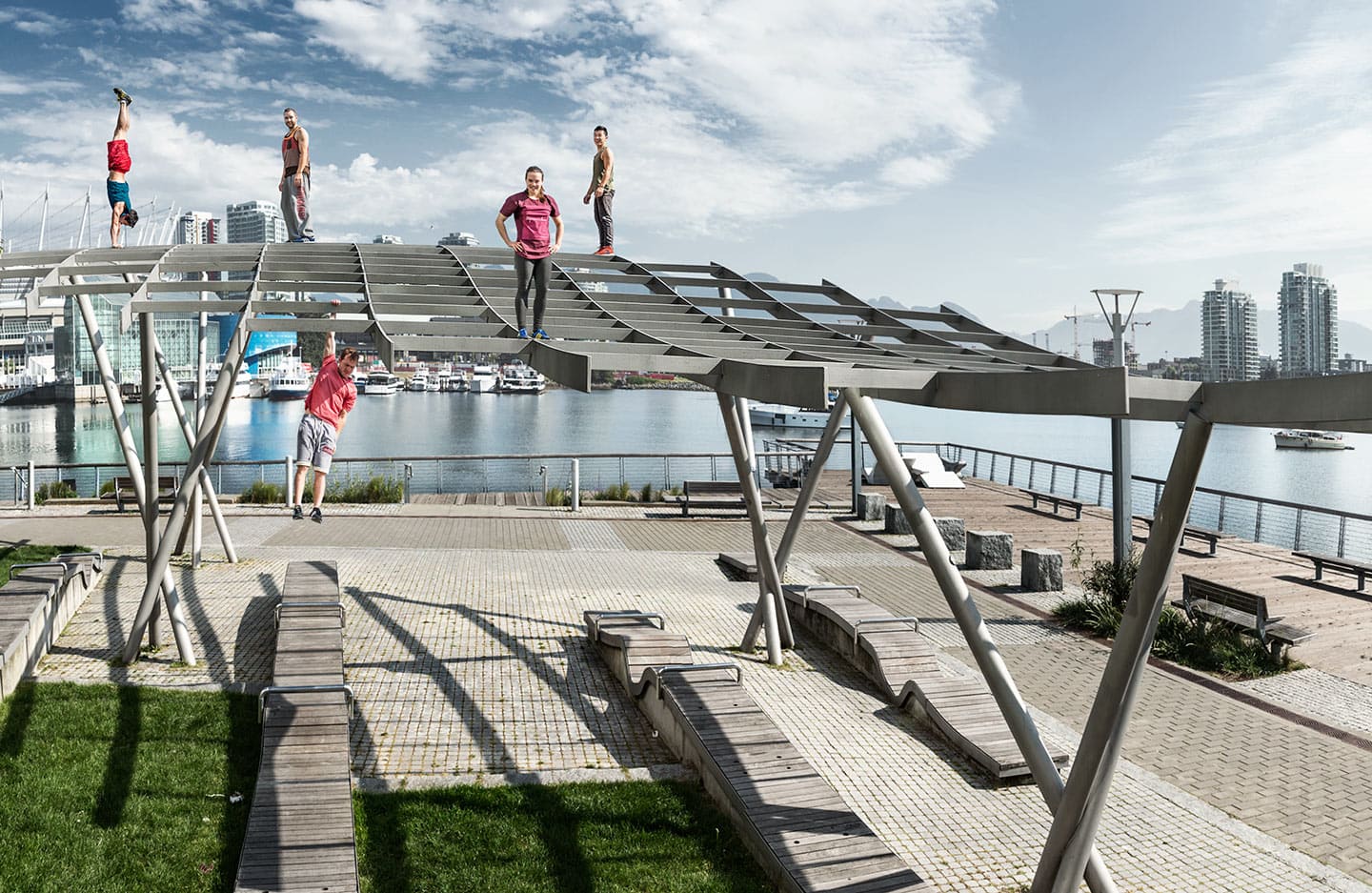 Parkour Athletes Pose for Image at Park on Scaffolding Bright Skies Handstand