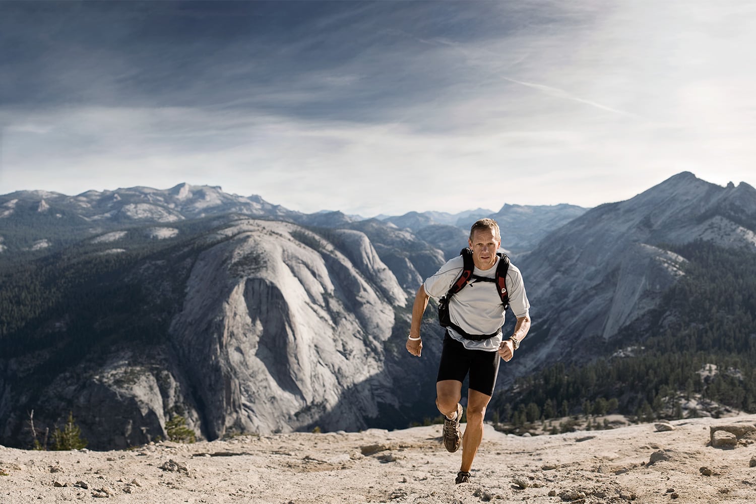 Athletic-lifestyle-man-charlie-engle-running-up-half-dome-Rod-McLean