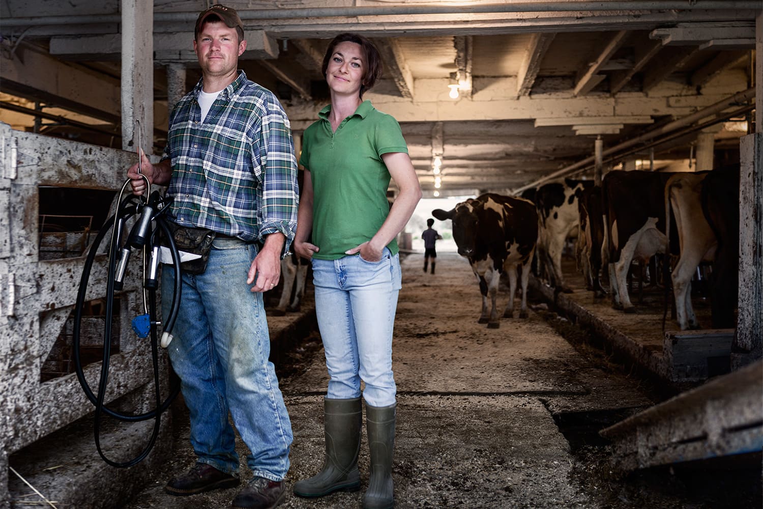 Male-Female-Dairy-Farmers-portrait-barn-with-cows-Rod-McLean